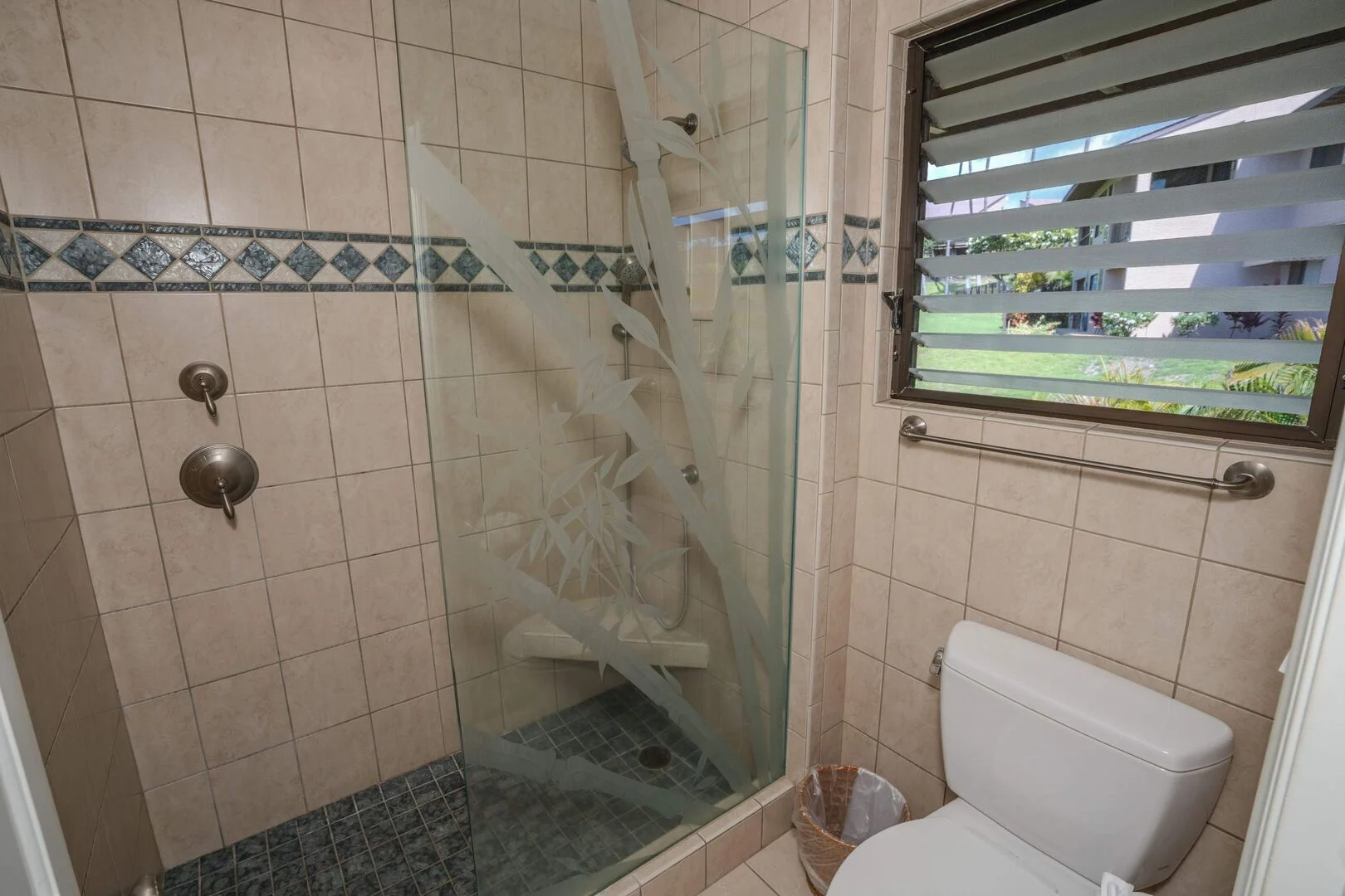 Walk-in glass shower with bamboo-etched glass
