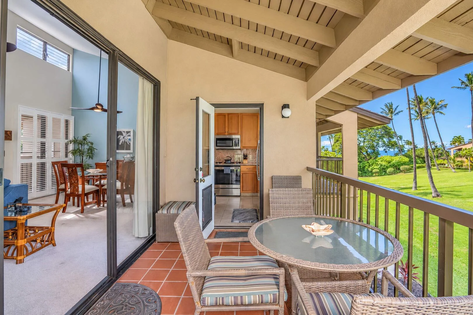 Lanai looking toward the living room and kitchen with lawn and palm views