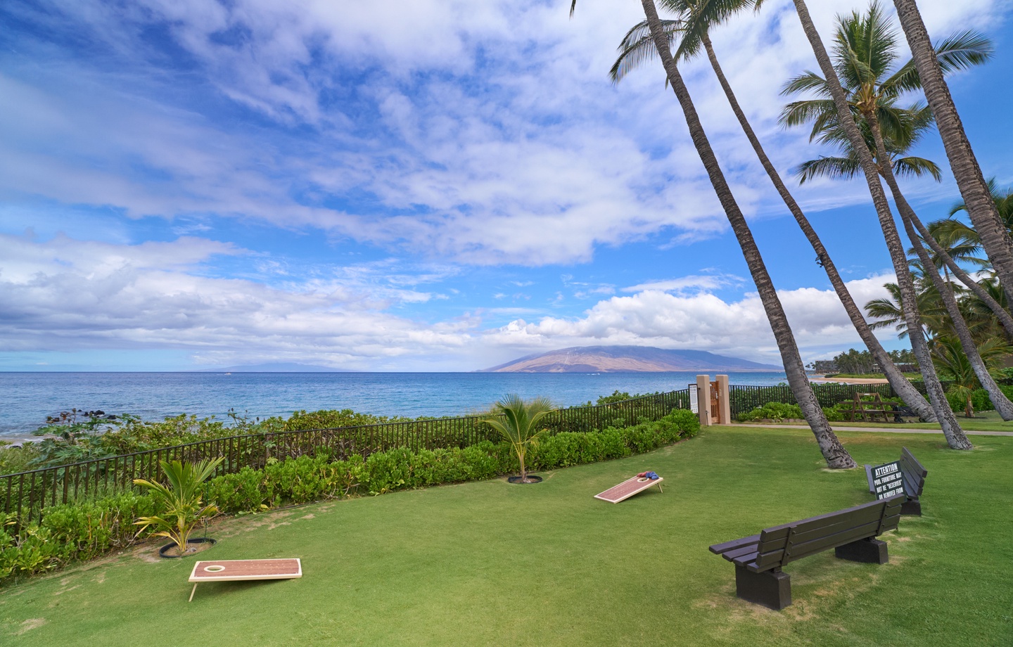 Oceanfront lawn with cornhole games and island views