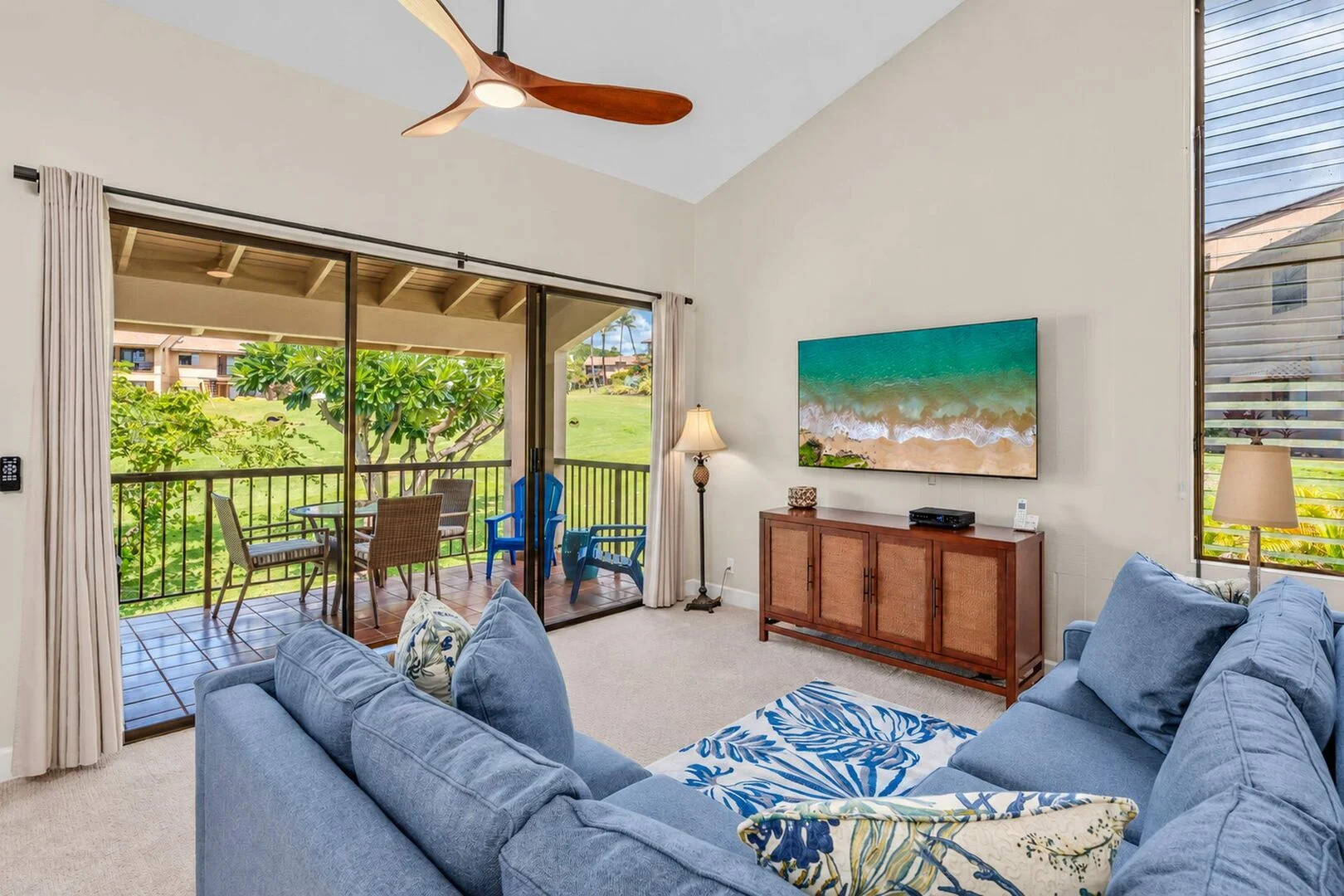 Living room with TV and sliding doors to the garden-view lanai